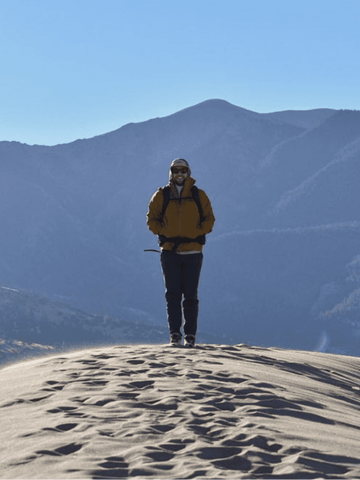 Cancer-free Fabian in the Great Sand Dunes. A symbol of resilience, strength, and embracing life's victories.